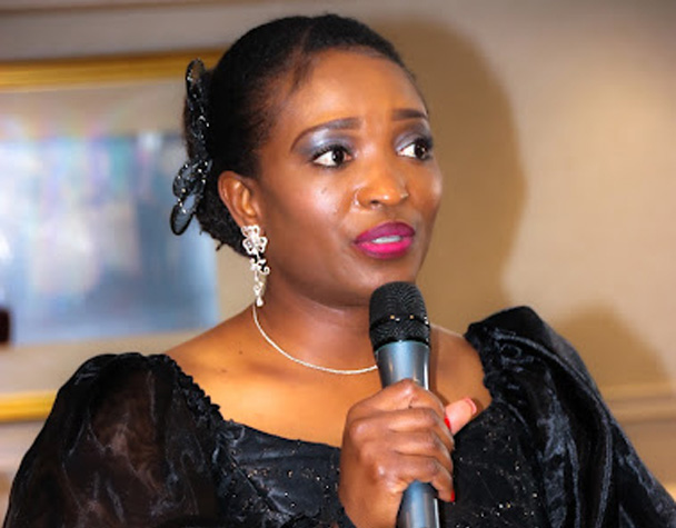 Bukola Jolugbo speaking at an event with microphone
