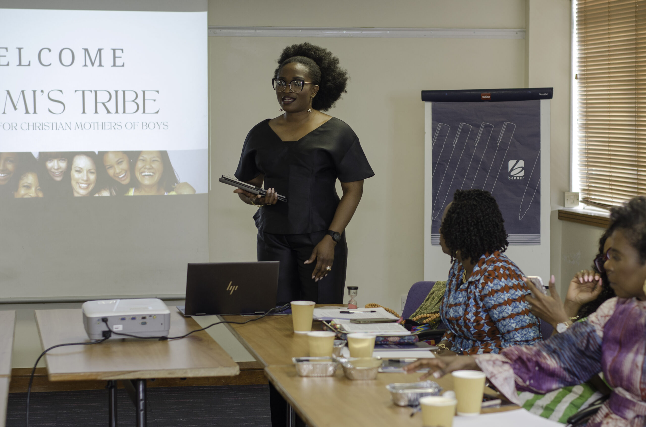 Bukola Jolugbo facilitating an interactive workshop and presenting to an audience